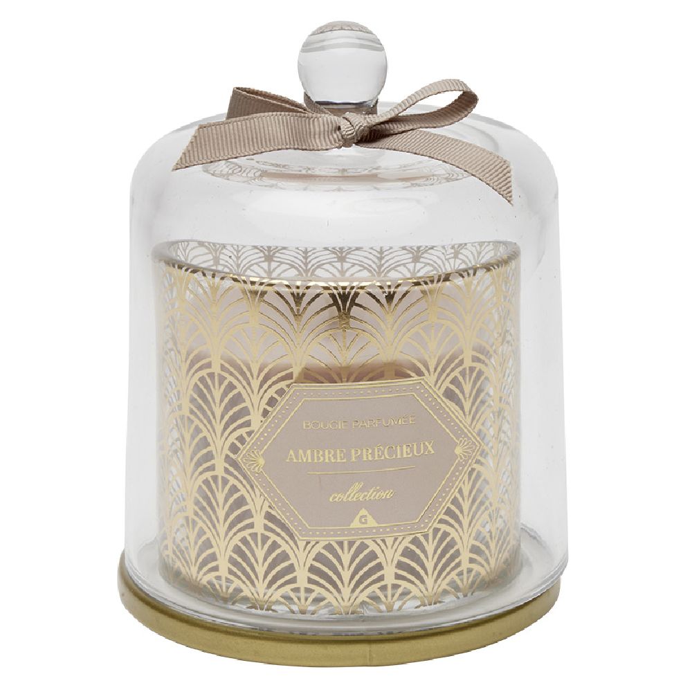 Beige scented candle under transparent golden bell