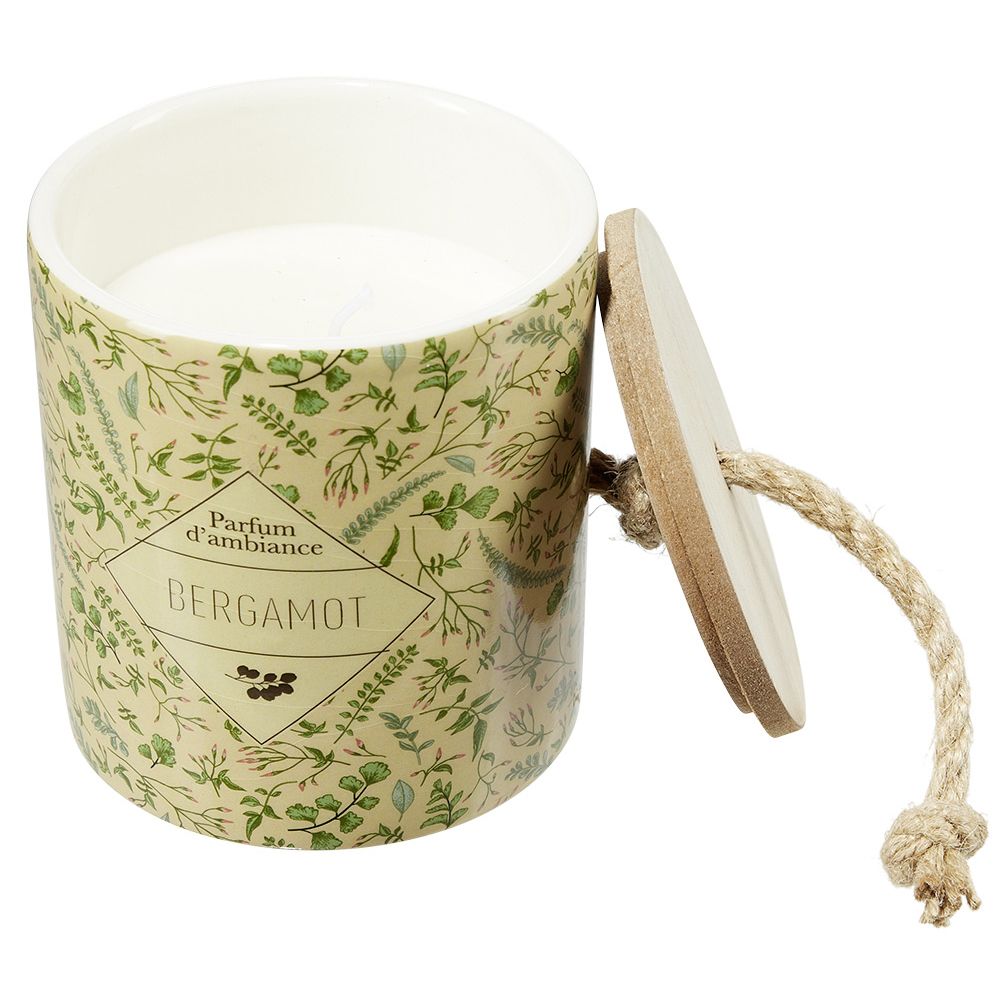 Candle in a ceramic pot with a plant design