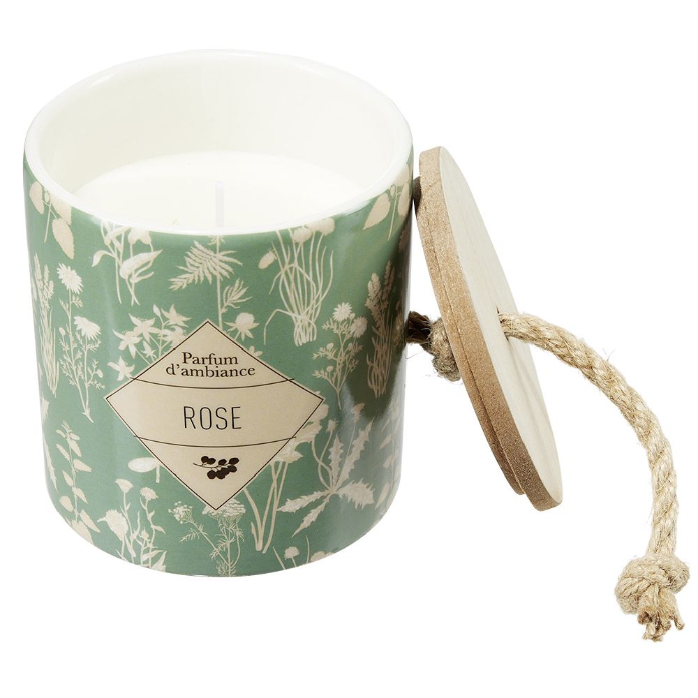 Candle in a ceramic pot with a plant design